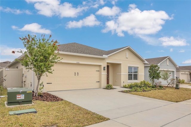 single story home featuring a garage and a front lawn