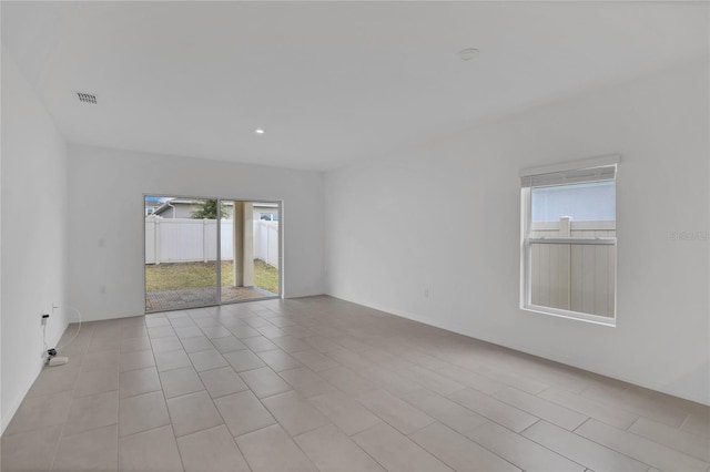 unfurnished room featuring plenty of natural light