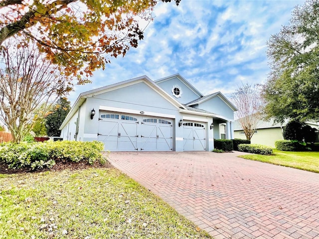 view of front of home with a front yard and a garage