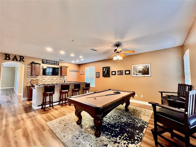 recreation room with ceiling fan, light hardwood / wood-style floors, bar area, and pool table