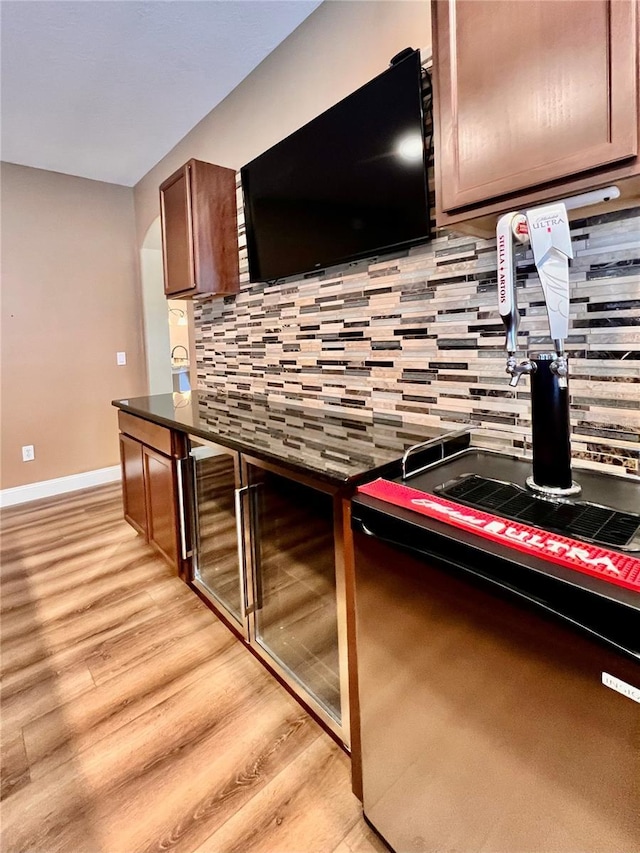 kitchen with light hardwood / wood-style flooring and tasteful backsplash