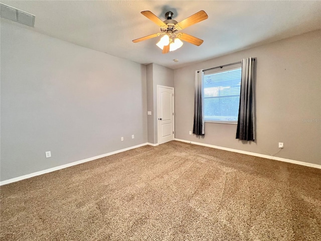 spare room featuring ceiling fan and carpet