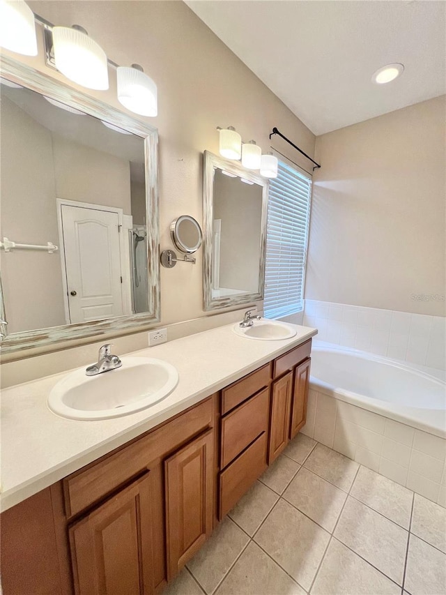 bathroom with tile patterned flooring, shower with separate bathtub, and vanity