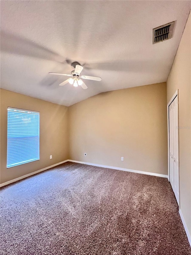 carpeted spare room with ceiling fan