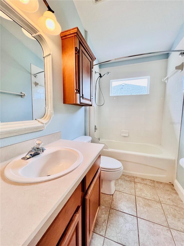 full bathroom featuring tiled shower / bath combo, vanity, toilet, and tile patterned flooring