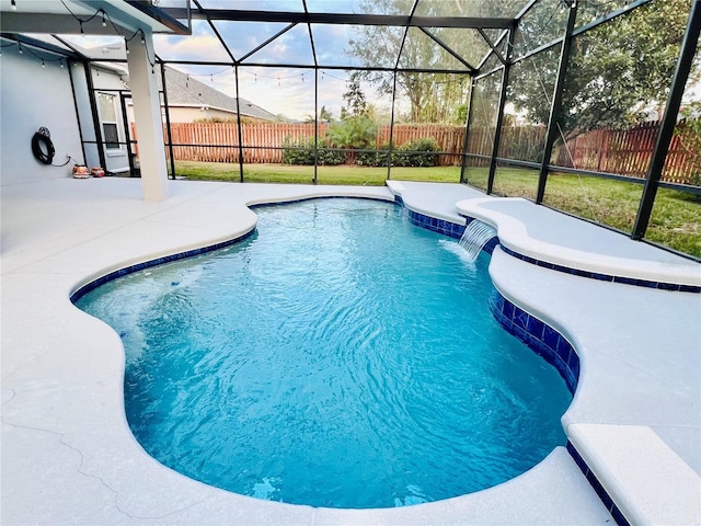 view of pool with glass enclosure, a patio area, a lawn, and pool water feature