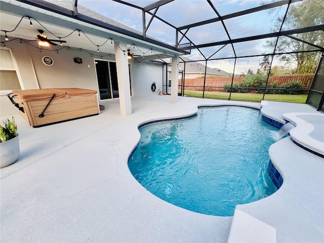 view of pool with a patio area, a lanai, a hot tub, and pool water feature