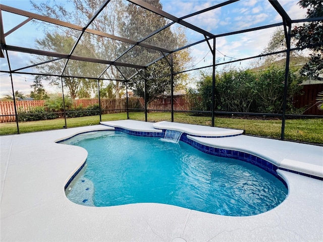 view of pool with a lanai, pool water feature, and a yard