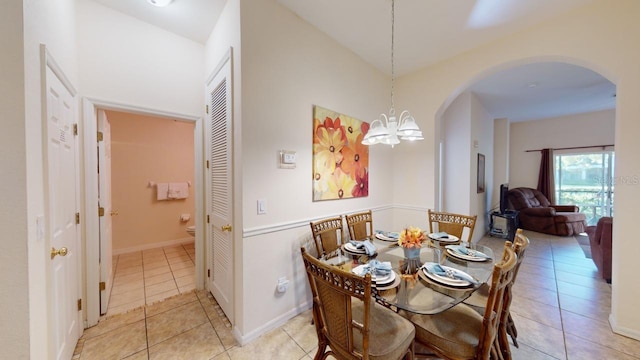 tiled dining space with an inviting chandelier