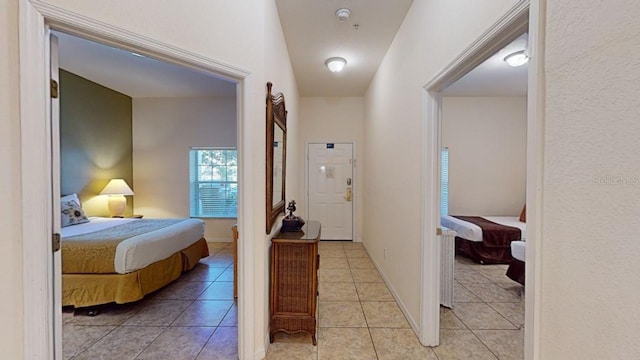 hallway featuring light tile patterned floors