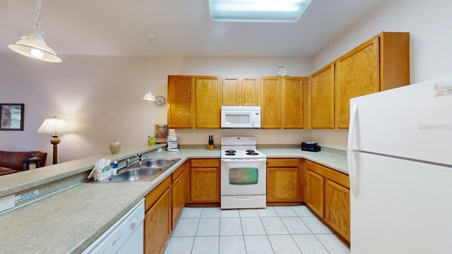 kitchen with pendant lighting, white appliances, sink, and light tile patterned floors