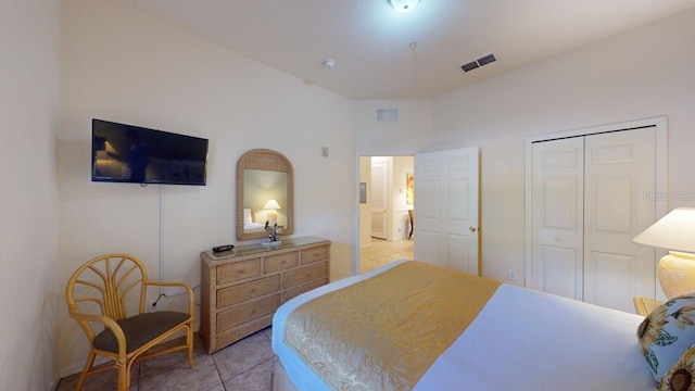 bedroom with light tile patterned floors and a closet