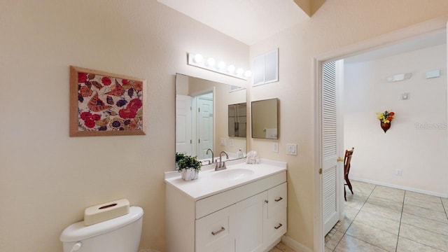 bathroom with tile patterned floors, vanity, and toilet