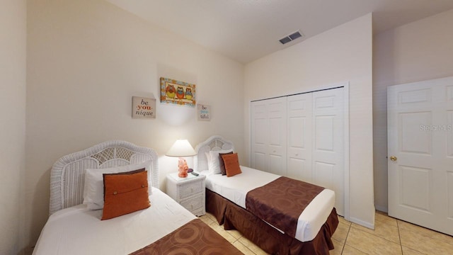 bedroom featuring a closet and light tile patterned floors