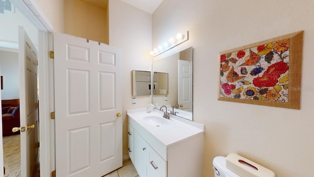 bathroom featuring tile patterned flooring, vanity, and toilet