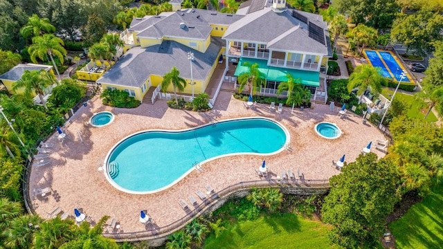 view of swimming pool with a patio and a hot tub