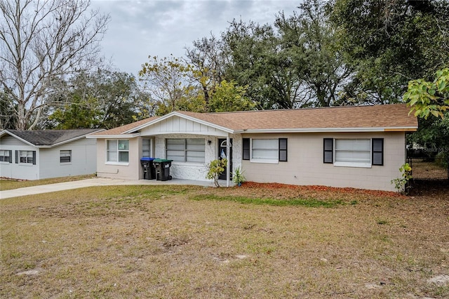 ranch-style home with a front lawn