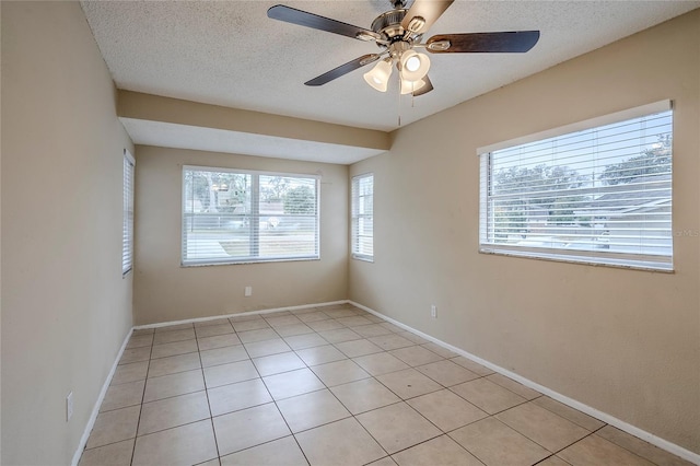 tiled spare room featuring ceiling fan and a textured ceiling