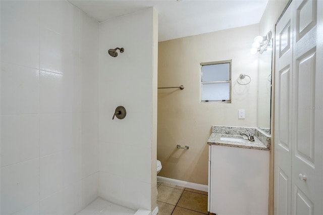 bathroom featuring tile patterned floors, toilet, vanity, and a shower