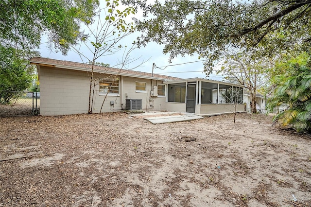 rear view of property featuring a sunroom, a patio, and central air condition unit