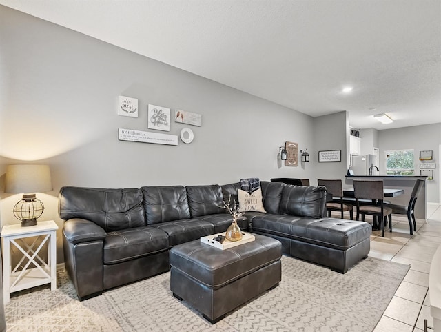 tiled living room featuring a textured ceiling