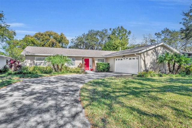 ranch-style house featuring a garage and a front yard