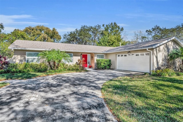 single story home with a front lawn and a garage