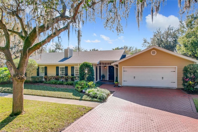 ranch-style house featuring a front yard and a garage