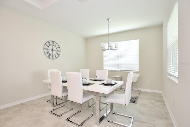 tiled dining area with an inviting chandelier