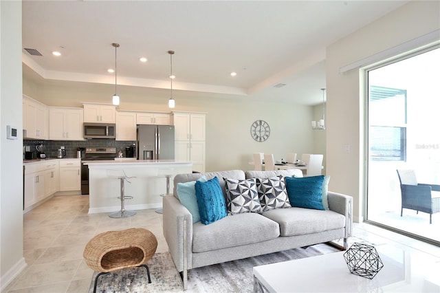 tiled living room featuring a raised ceiling