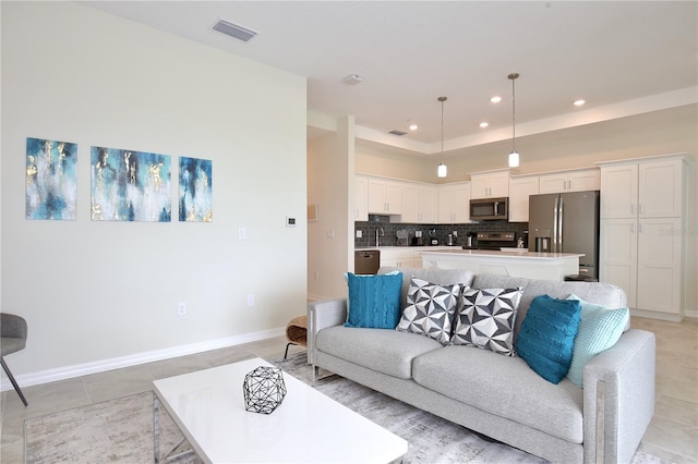 tiled living room featuring sink