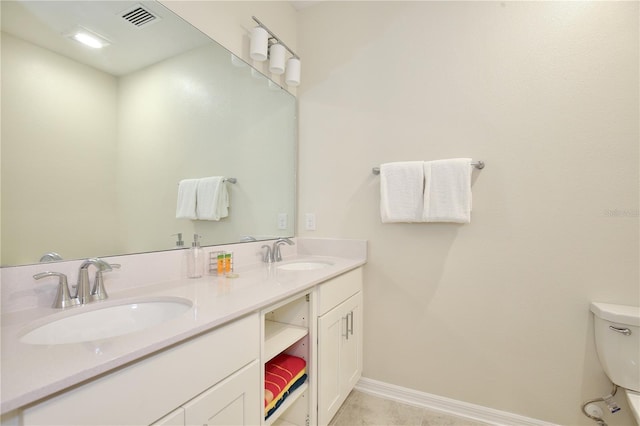 bathroom featuring toilet and vanity