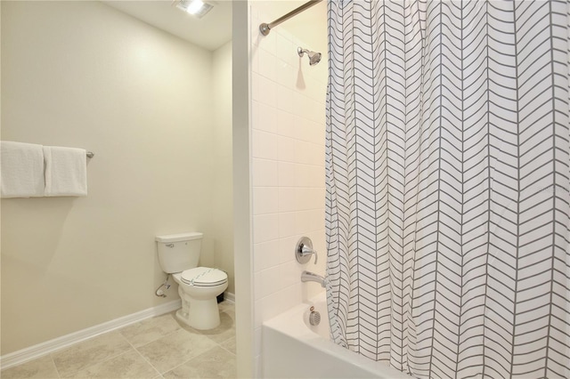 bathroom featuring tiled shower / bath combo and toilet