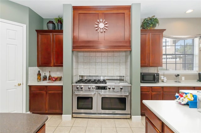 kitchen featuring decorative backsplash, light tile patterned floors, and appliances with stainless steel finishes