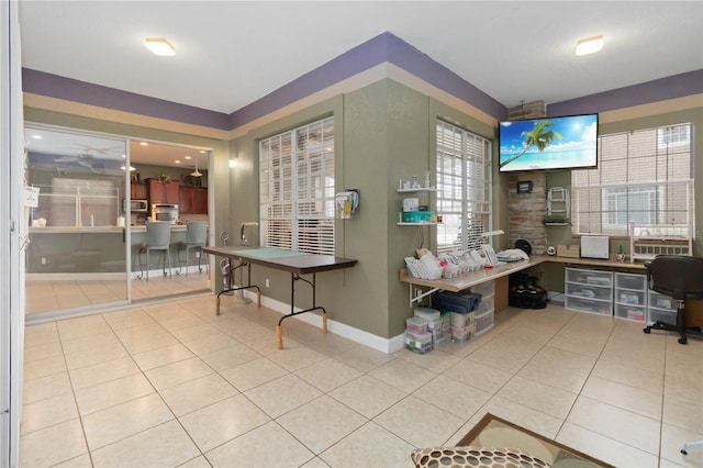 office with light tile patterned floors and a healthy amount of sunlight