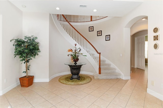 stairway featuring tile patterned flooring