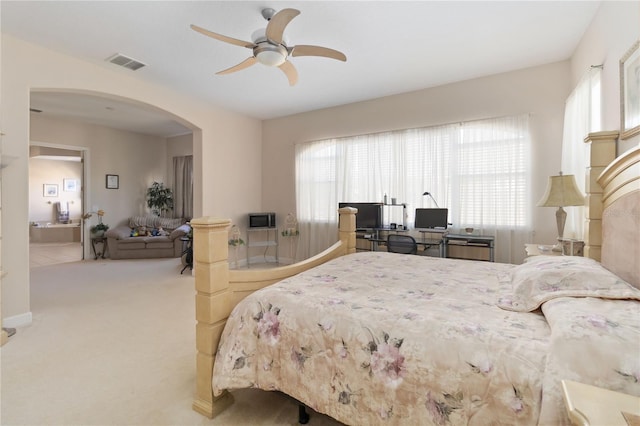 carpeted bedroom featuring ceiling fan and multiple windows