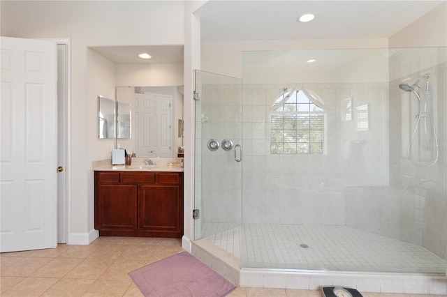 bathroom with vanity, a shower with door, and tile patterned flooring