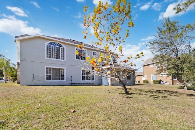 back of house with a lawn