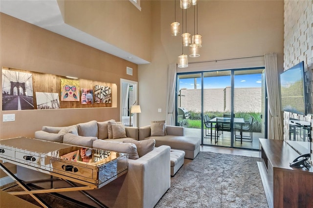 living room featuring a towering ceiling