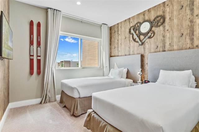 carpeted bedroom featuring wooden walls