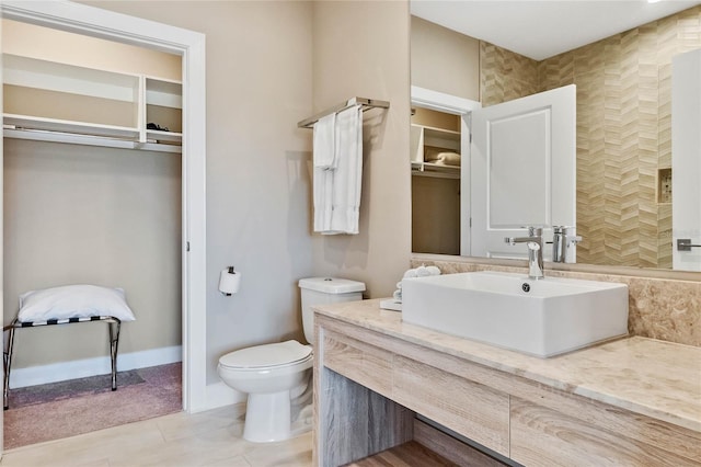 bathroom featuring toilet, vanity, and tile patterned floors