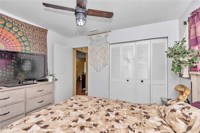 bedroom featuring ceiling fan, a closet, and a textured ceiling