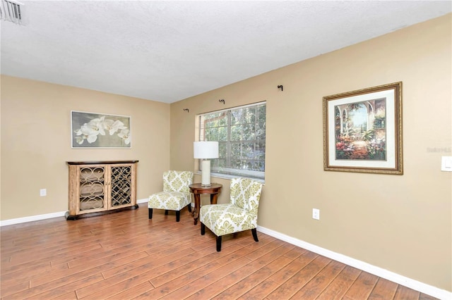 living area with hardwood / wood-style flooring