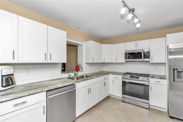 kitchen with sink, stainless steel appliances, and white cabinets