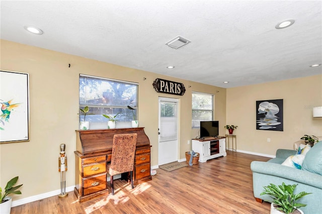 office area with a textured ceiling and hardwood / wood-style flooring