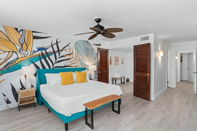 bedroom with ceiling fan and light hardwood / wood-style flooring