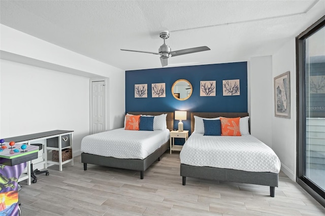 bedroom featuring ceiling fan, a closet, and a textured ceiling