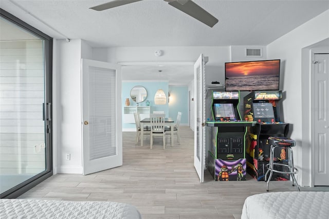 bedroom with a textured ceiling and ceiling fan