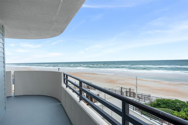 balcony with a beach view and a water view